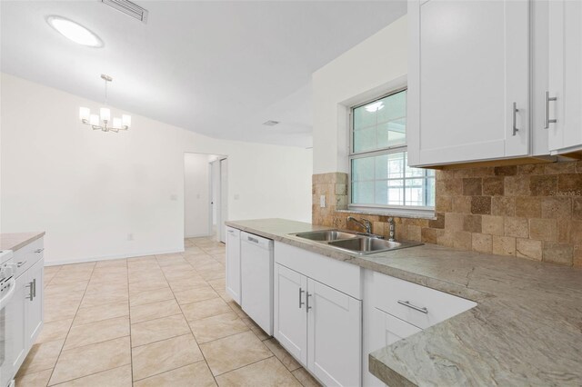 23 Pennfield Ln, Palm Coast, FL 32164 - kitchen featuring white dishwasher, backsplash, white cabinetry, decorative light fixtures, and light countertops