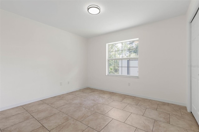 23 Pennfield Ln, Palm Coast, FL 32164 - empty room featuring light tile patterned floors and baseboards