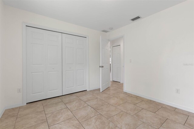 23 Pennfield Ln, Palm Coast, FL 32164 - unfurnished bedroom with a closet and light tile patterned floors