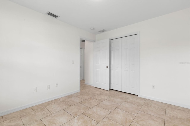 23 Pennfield Ln, Palm Coast, FL 32164 - unfurnished bedroom with a closet and light tile patterned flooring