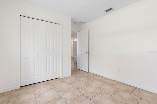 23 Pennfield Ln, Palm Coast, FL 32164 - unfurnished bedroom with a closet and light tile patterned floors