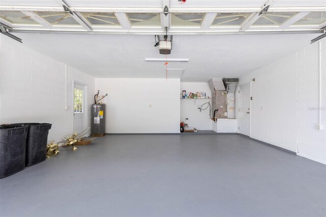 23 Pennfield Ln, Palm Coast, FL 32164 - garage with water heater, a garage door opener, and concrete block wall