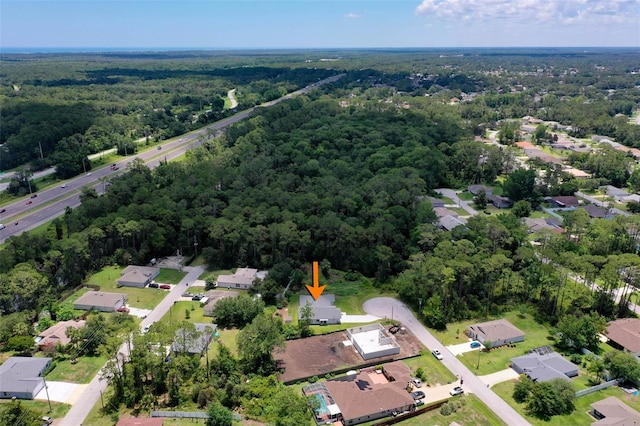 23 Pennfield Ln, Palm Coast, FL 32164 - aerial overview of property's location featuring a heavily wooded area and nearby suburban area