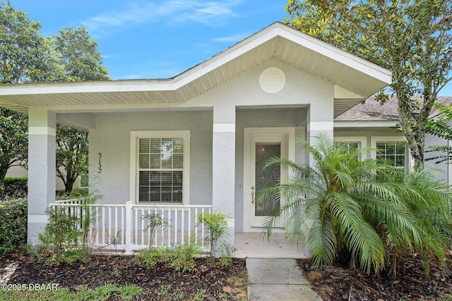 3132 Connemara Dr, Ormond Beach, FL 32174 - doorway to property featuring covered porch and stucco siding