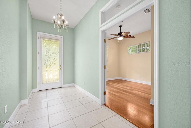 3132 Connemara Dr, Ormond Beach, FL 32174 - foyer featuring a chandelier, light wood finished floors, and ceiling fan