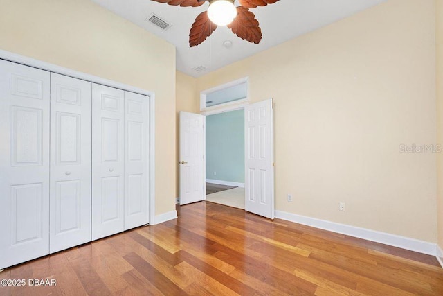 3132 Connemara Dr, Ormond Beach, FL 32174 - unfurnished bedroom with wood finished floors, a closet, and a ceiling fan