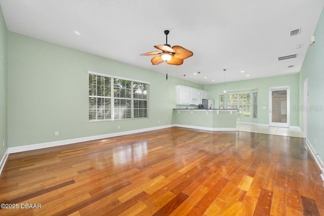 3132 Connemara Dr, Ormond Beach, FL 32174 - unfurnished living room with light wood-style floors, a ceiling fan, and recessed lighting