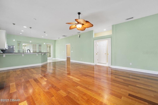 3132 Connemara Dr, Ormond Beach, FL 32174 - unfurnished living room with a ceiling fan, light wood-style flooring, and recessed lighting
