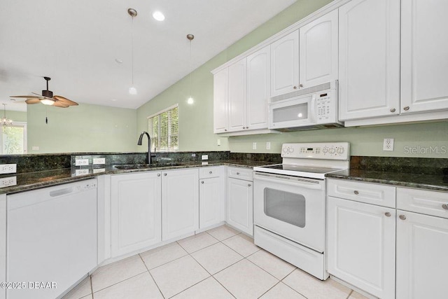 3132 Connemara Dr, Ormond Beach, FL 32174 - kitchen featuring white appliances, white cabinets, dark stone countertops, and ceiling fan