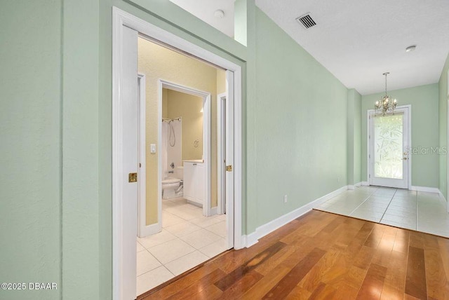3132 Connemara Dr, Ormond Beach, FL 32174 - corridor with a chandelier and tile patterned flooring