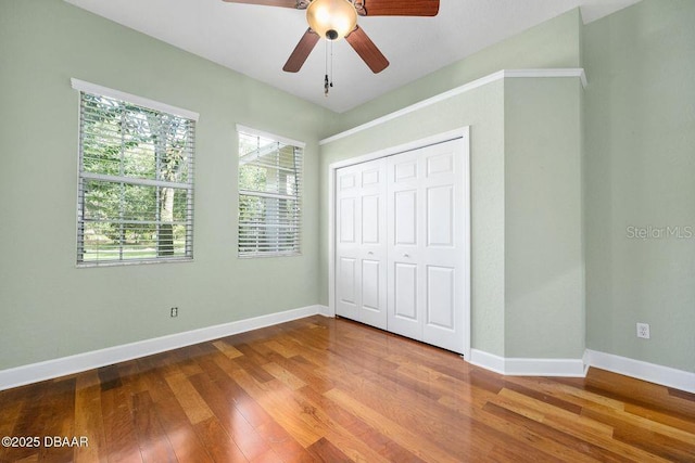3132 Connemara Dr, Ormond Beach, FL 32174 - unfurnished bedroom featuring wood finished floors, a closet, and a ceiling fan