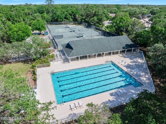 3132 Connemara Dr, Ormond Beach, FL 32174 - community pool featuring a forest view and a patio