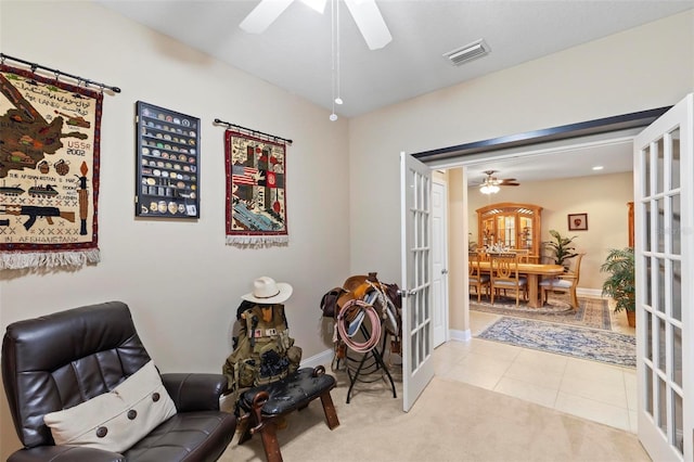 105 Spoonbill Dr, Palm Coast, FL 32164 - living area with a ceiling fan, french doors, carpet flooring, and tile patterned flooring