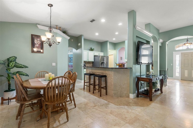 5 Senora Ct, Palm Coast, FL 32164 - dining area with arched walkways, recessed lighting, a chandelier, and light tile patterned floors