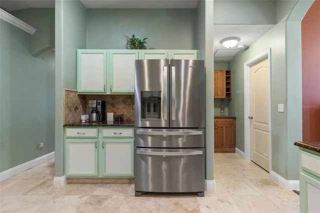 5 Senora Ct, Palm Coast, FL 32164 - kitchen with stainless steel refrigerator with ice dispenser, dark stone counters, backsplash, and light tile patterned floors
