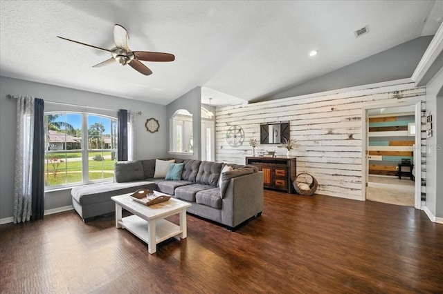 44 Edward, Palm Coast, FL 32164 - living area with lofted ceiling, wood finished floors, a ceiling fan, wooden walls, and a textured ceiling