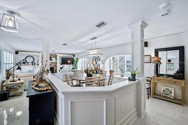 1108 Shockney Dr, Ormond Beach, FL 32174 - kitchen with decorative columns, open floor plan, healthy amount of natural light, and white cabinets