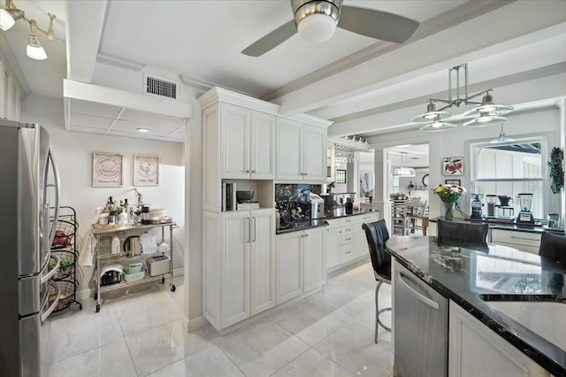 1108 Shockney Dr, Ormond Beach, FL 32174 - kitchen with stainless steel appliances, a ceiling fan, white cabinets, decorative light fixtures, and dark stone countertops