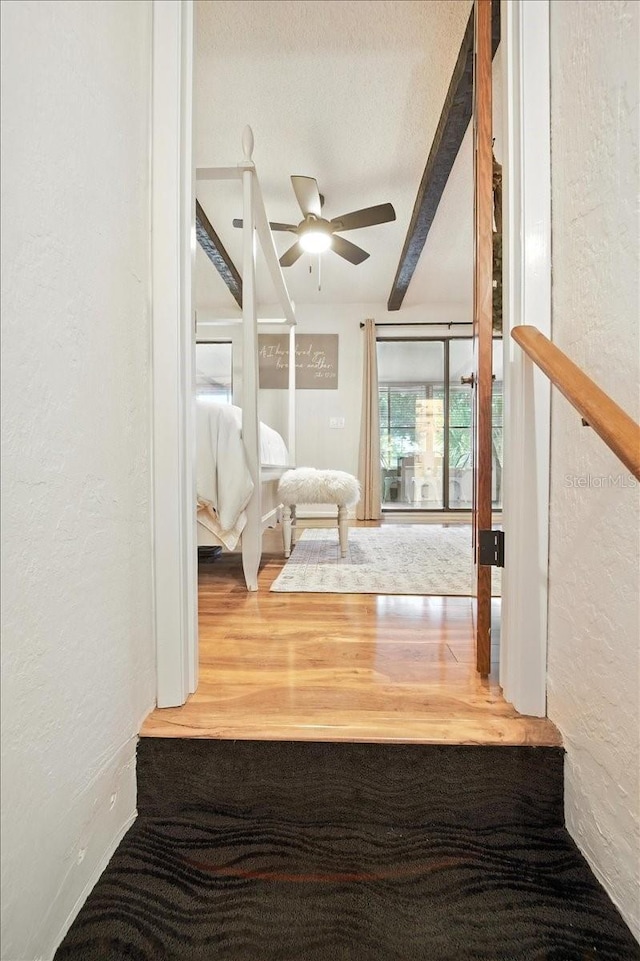 1108 Shockney Dr, Ormond Beach, FL 32174 - hall featuring a textured wall, beam ceiling, wood finished floors, and a textured ceiling