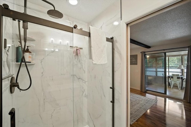 1108 Shockney Dr, Ormond Beach, FL 32174 - full bathroom with a textured ceiling, a marble finish shower, and wood finished floors