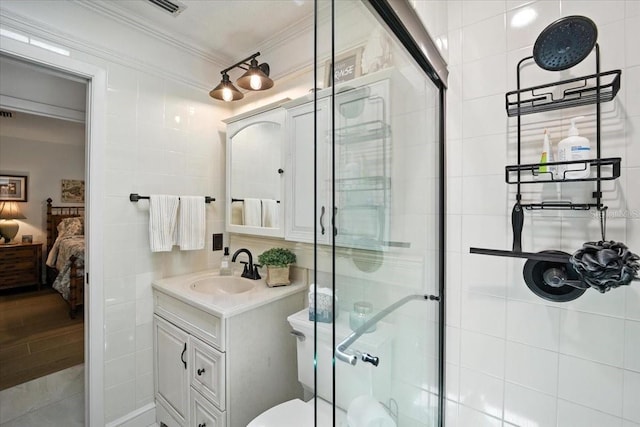 1108 Shockney Dr, Ormond Beach, FL 32174 - bathroom with connected bathroom, vanity, a shower stall, tile walls, and ornamental molding
