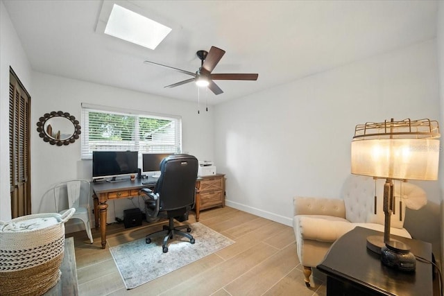 1108 Shockney Dr, Ormond Beach, FL 32174 - home office with a skylight, light wood-style flooring, and ceiling fan
