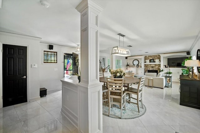 1108 Shockney Dr, Ormond Beach, FL 32174 - dining room featuring crown molding, a stone fireplace, and light marble finish floors