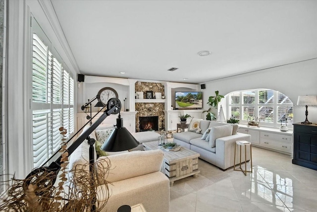 1108 Shockney Dr, Ormond Beach, FL 32174 - living area with plenty of natural light, a warm lit fireplace, and ornamental molding
