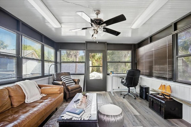 1108 Shockney Dr, Ormond Beach, FL 32174 - sunroom / solarium featuring wood finished floors, ceiling fan, an outdoor hangout area, and healthy amount of natural light