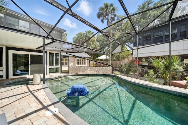 1108 Shockney Dr, Ormond Beach, FL 32174 - outdoor pool featuring an in-ground hot tub, glass enclosure, and a patio