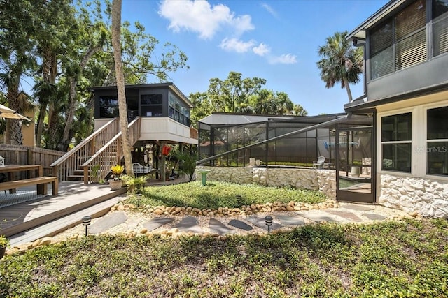 1108 Shockney Dr, Ormond Beach, FL 32174 - view of yard featuring stairway, a lanai, a deck, and a sunroom