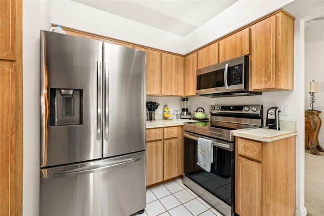 1 Ryberry Pl, Palm Coast, FL 32164 - kitchen with stainless steel appliances, light countertops, and light tile patterned floors