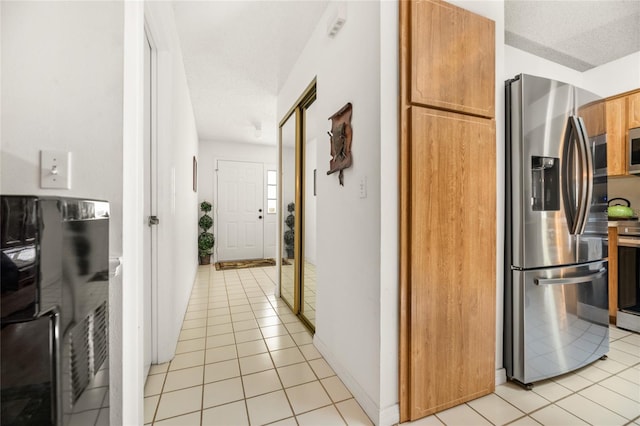 1 Ryberry Pl, Palm Coast, FL 32164 - kitchen featuring stainless steel appliances, light tile patterned floors, and a textured ceiling