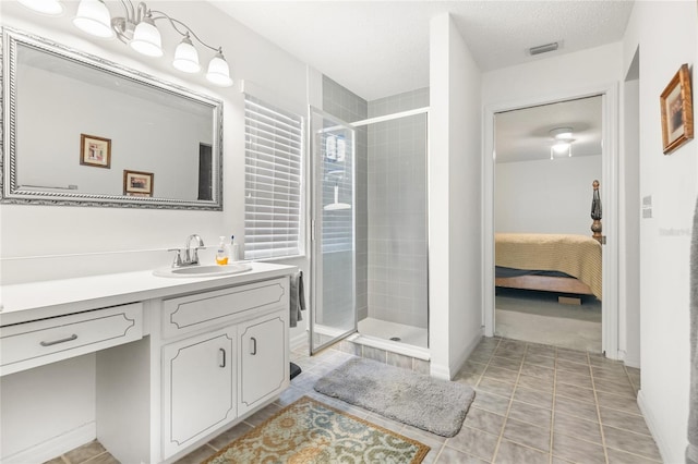 1 Ryberry Pl, Palm Coast, FL 32164 - ensuite bathroom with vanity, a shower stall, tile patterned floors, and a textured ceiling