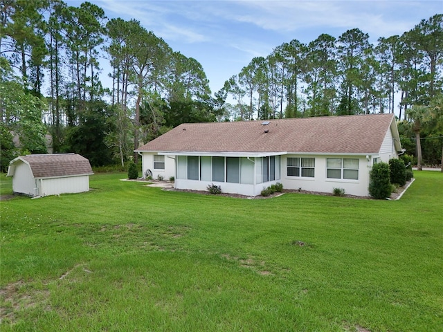 1 Ryberry Pl, Palm Coast, FL 32164 - back of house featuring a storage shed, a sunroom, a lawn, a shingled roof, and stucco siding