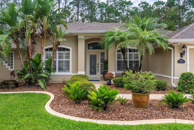 1254 Royal Pointe Ln, Ormond Beach, FL 32174 - property entrance featuring stucco siding and a shingled roof