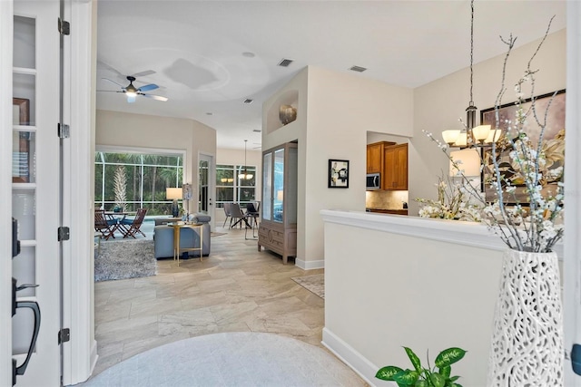 1254 Royal Pointe Ln, Ormond Beach, FL 32174 - foyer entrance with a chandelier, ceiling fan, and light marble finish floors