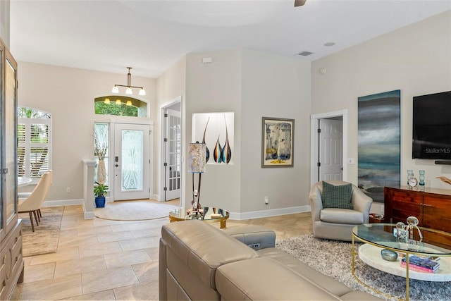 1254 Royal Pointe Ln, Ormond Beach, FL 32174 - living area with a chandelier and baseboards