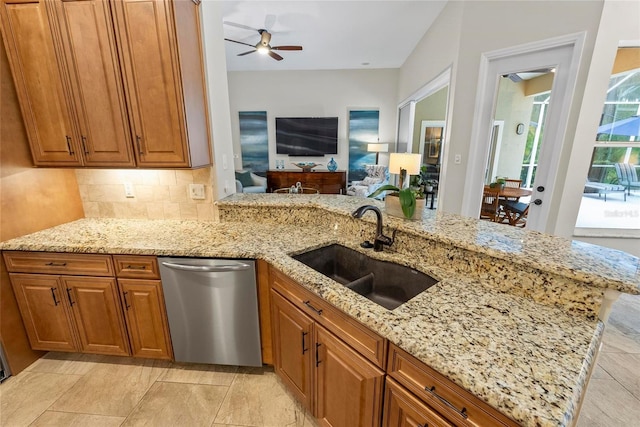 1254 Royal Pointe Ln, Ormond Beach, FL 32174 - kitchen featuring dishwasher, a ceiling fan, light stone counters, and brown cabinets