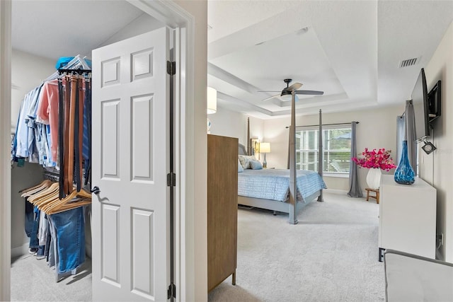 1254 Royal Pointe Ln, Ormond Beach, FL 32174 - carpeted bedroom with a tray ceiling and a ceiling fan