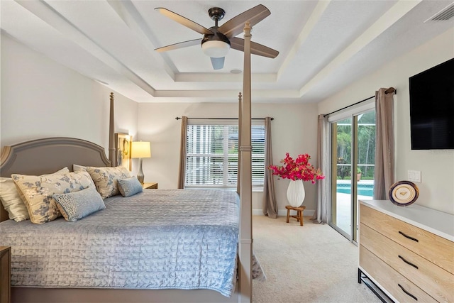 1254 Royal Pointe Ln, Ormond Beach, FL 32174 - bedroom with access to exterior, light colored carpet, a raised ceiling, and ceiling fan