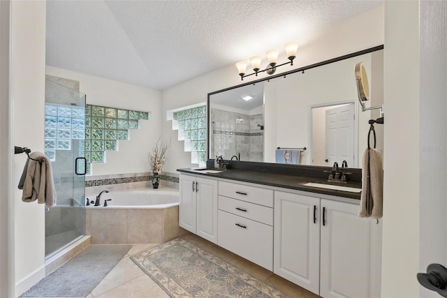 1254 Royal Pointe Ln, Ormond Beach, FL 32174 - full bathroom with a stall shower, double vanity, tile patterned flooring, a bath, and a textured ceiling