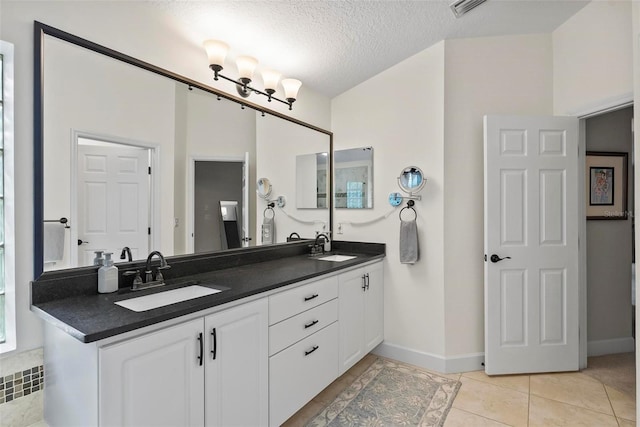 1254 Royal Pointe Ln, Ormond Beach, FL 32174 - full bath featuring double vanity, tile patterned flooring, and a textured ceiling