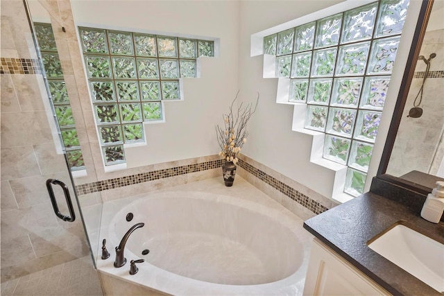 1254 Royal Pointe Ln, Ormond Beach, FL 32174 - bathroom with a garden tub, vanity, and a shower stall