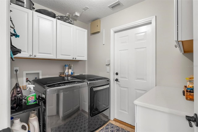 1254 Royal Pointe Ln, Ormond Beach, FL 32174 - washroom with washer and clothes dryer, cabinet space, a textured ceiling, and light tile patterned floors