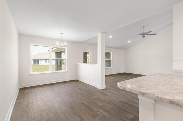 18 Slipper Orchid Trl E, Palm Coast, FL 32164 - unfurnished living room with dark wood-style flooring, a chandelier, ceiling fan, vaulted ceiling, and recessed lighting