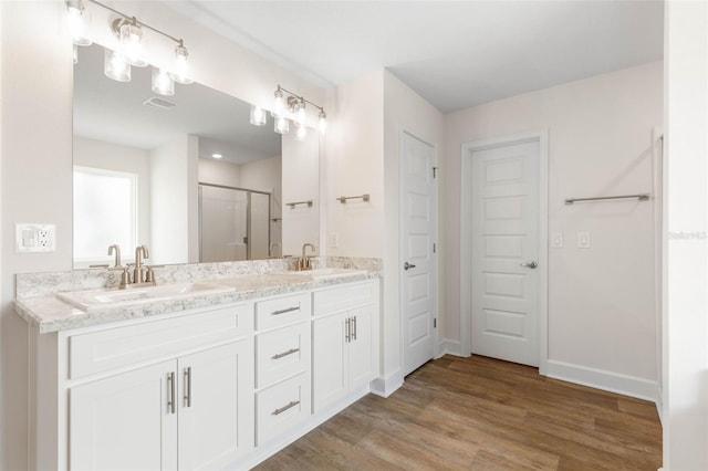 18 Slipper Orchid Trl E, Palm Coast, FL 32164 - full bathroom featuring double vanity, a shower stall, and wood finished floors