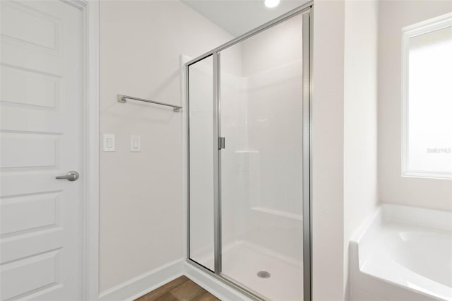 18 Slipper Orchid Trl E, Palm Coast, FL 32164 - bathroom with a shower stall, a garden tub, and wood finished floors