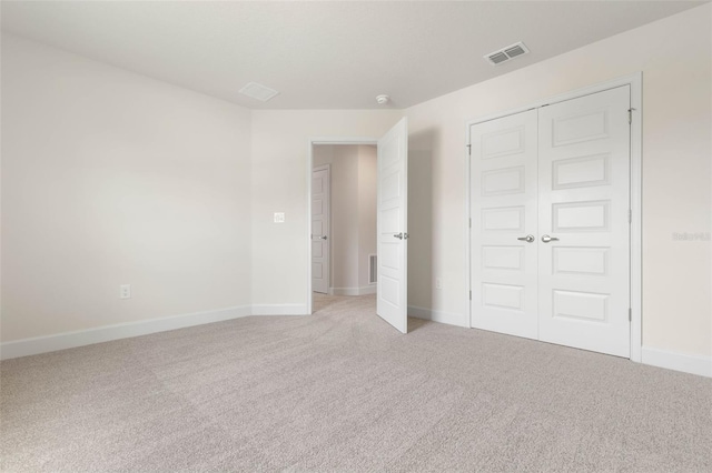 18 Slipper Orchid Trl E, Palm Coast, FL 32164 - unfurnished bedroom with light colored carpet and a closet