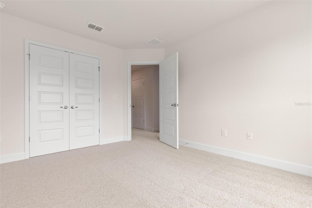 18 Slipper Orchid Trl E, Palm Coast, FL 32164 - unfurnished bedroom with light colored carpet and a closet